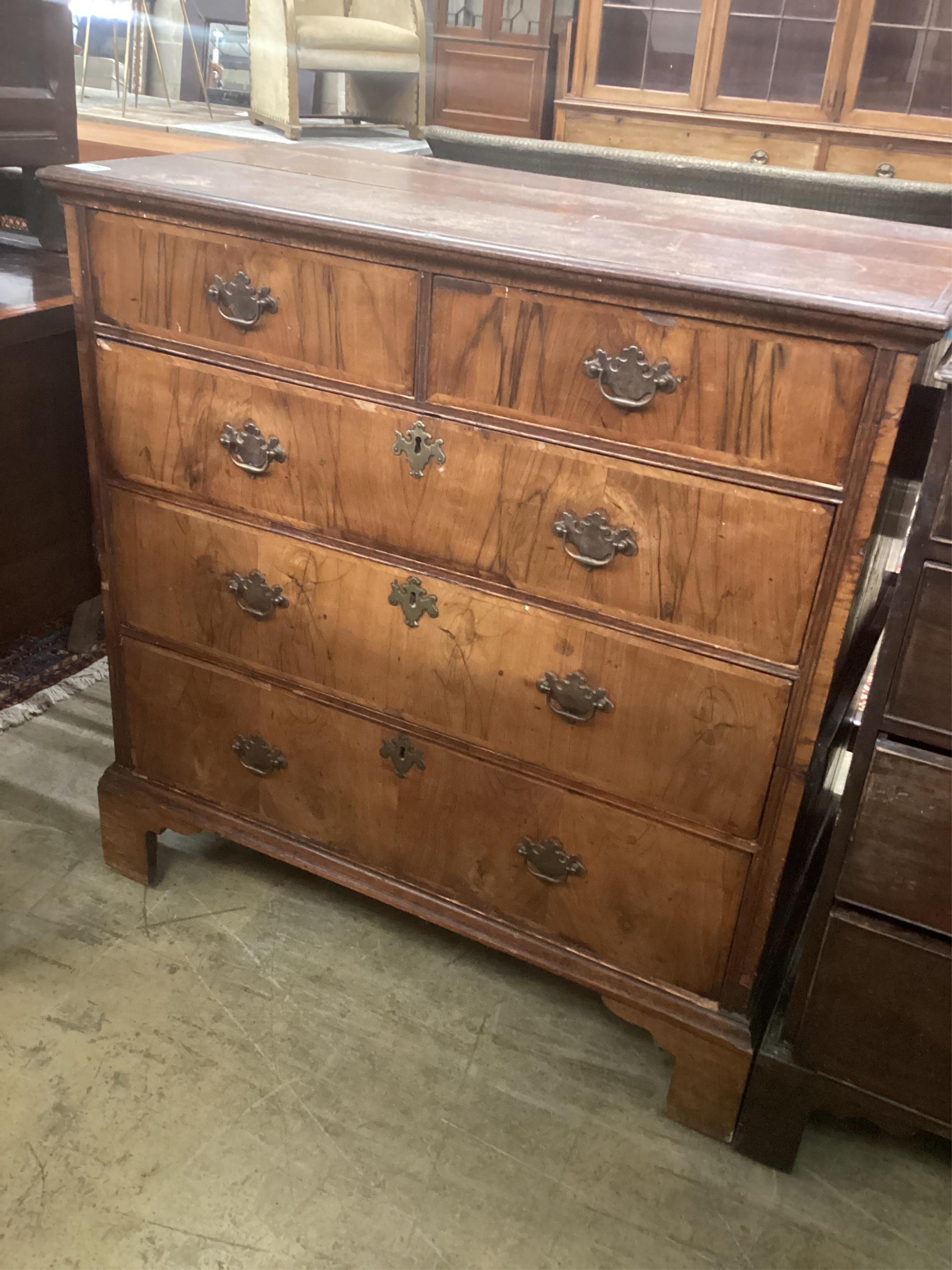 An 18th century oak and walnut chest, width 99cm, depth 54cm, height 102cm. Condition - poor